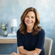 Portrait of a smiling woman looking healthy and relieved, representing a satisfied customer.